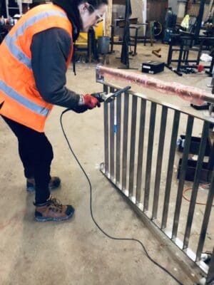 Amanda filing off any sharp edged before polishing the steel.