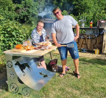 Two men having a BBQ with a bespoke plasma cut table