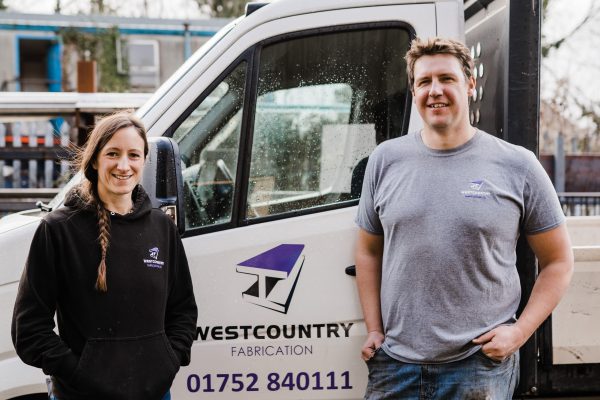 Women and man stood by a steel fabrication truck