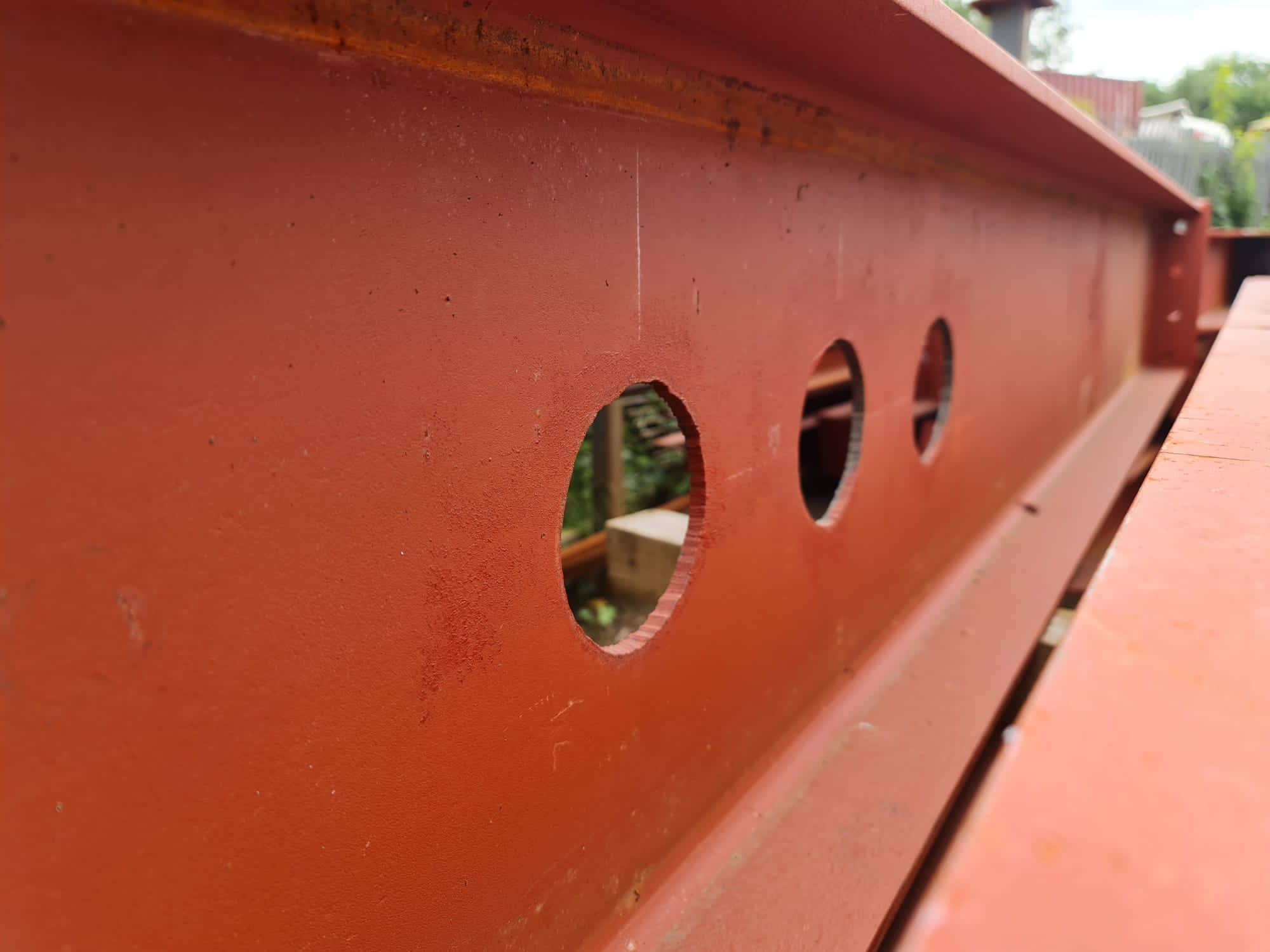 Primer steel beam with holes in web