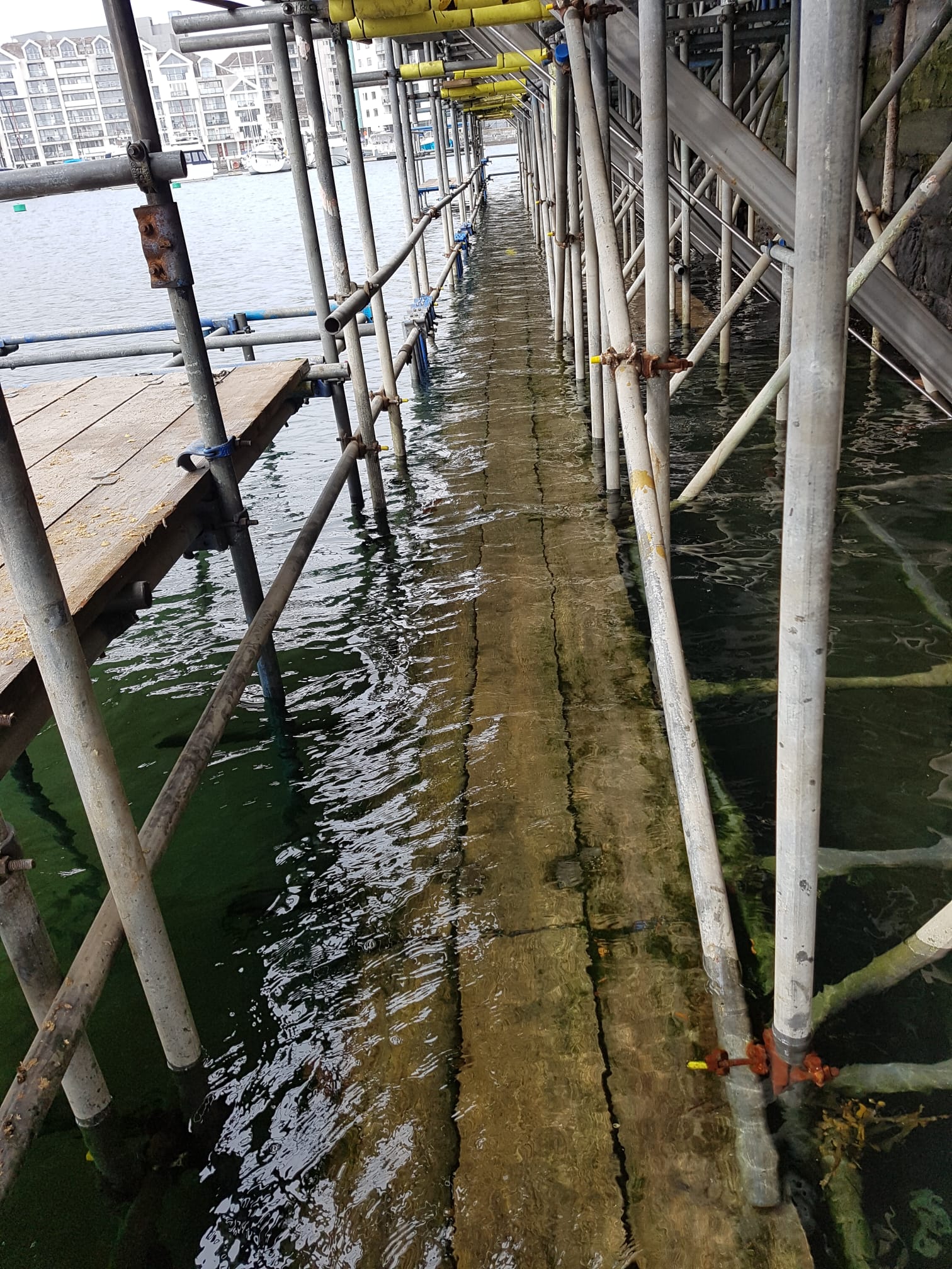 Scaffold in the harbour with incoming tide