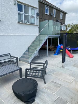 Steel staircase to balcony with glass balustrade