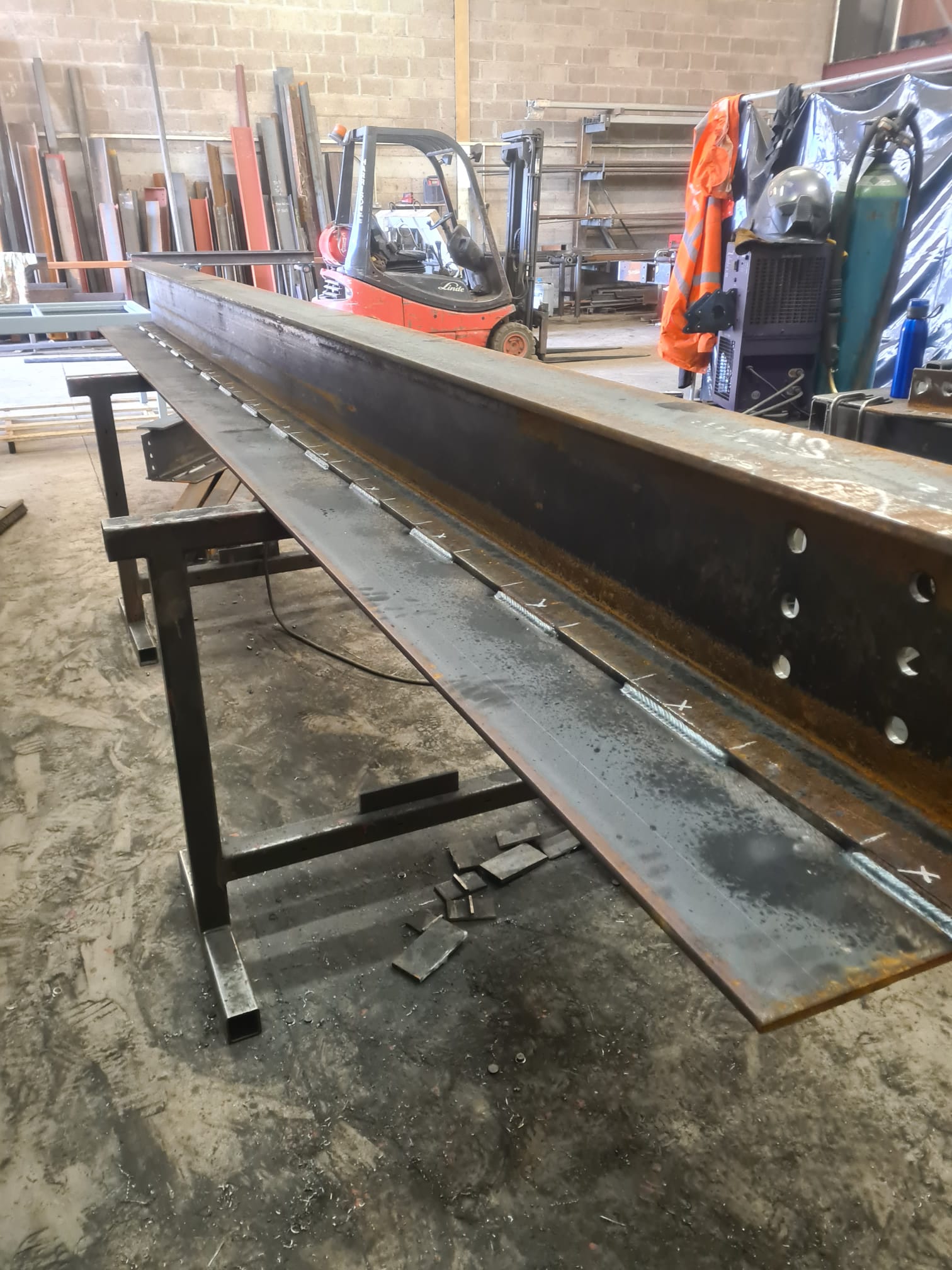 Beam with welded plate